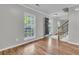Spacious living room featuring wood floors, neutral paint, and natural light from a large window at 543 Castle Hall Rd, Mount Pleasant, SC 29464