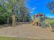 A charming playground with swings, a slide, and a wooden play structure in a community park at 543 Castle Hall Rd, Mount Pleasant, SC 29464