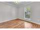 Light-filled room with wood floors, neutral paint, and a large window at 543 Castle Hall Rd, Mount Pleasant, SC 29464