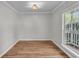 Sunlit room with wood floors, neutral paint, crown molding, and a large window at 543 Castle Hall Rd, Mount Pleasant, SC 29464