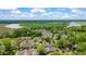 Stunning aerial view of a home in a lush community near a tranquil lake and beautiful green fields at 5514 Colonial Chatsworth Cir, North Charleston, SC 29418