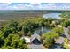 Stunning aerial view of a community pool, clubhouse, and pond surrounded by lush greenery and beautiful landscapes at 5514 Colonial Chatsworth Cir, North Charleston, SC 29418