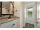 Charming bathroom featuring granite countertops, a patterned mirror, and modern fixtures at 5514 Colonial Chatsworth Cir, North Charleston, SC 29418
