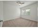 Bright, carpeted bedroom with a ceiling fan and a window letting in natural light at 5514 Colonial Chatsworth Cir, North Charleston, SC 29418