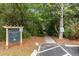 Entrance to community dock with sign, surrounded by lush trees at 5514 Colonial Chatsworth Cir, North Charleston, SC 29418