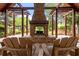 Outdoor fireplace with wooden chairs for relaxing providing a cozy spot to enjoy the serene view at 5514 Colonial Chatsworth Cir, North Charleston, SC 29418