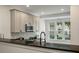 Well-lit kitchen featuring stainless steel appliances, granite countertops, and a view of the front yard at 5514 Colonial Chatsworth Cir, North Charleston, SC 29418