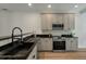 Modern kitchen featuring granite countertops, stainless steel appliances, and stylish cabinetry at 5514 Colonial Chatsworth Cir, North Charleston, SC 29418
