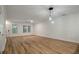Bright, open-concept living room with hardwood floors and natural light filtering through the windows at 5514 Colonial Chatsworth Cir, North Charleston, SC 29418