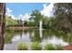 Scenic pond with a fountain and a charming wooden structure, surrounded by lush greenery at 5514 Colonial Chatsworth Cir, North Charleston, SC 29418