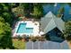 Aerial view of a community pool area with lounge chairs, tables, and lush landscaping near a peaceful pond at 5514 Colonial Chatsworth Cir, North Charleston, SC 29418