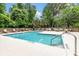 Inviting community pool surrounded by lounge chairs and lush greenery, perfect for relaxation and recreation at 5514 Colonial Chatsworth Cir, North Charleston, SC 29418