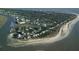 Breathtaking aerial view of coastal homes nestled along the shoreline and surrounded by lush greenery at 60 Rice Ln, Edisto Beach, SC 29438