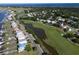 Aerial view of a neighborhood with homes lining the waterway and a golf course at 60 Rice Ln, Edisto Beach, SC 29438