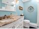 Stylish bathroom with marble countertop, white cabinets, and modern fixtures at 60 Rice Ln, Edisto Beach, SC 29438