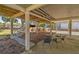 Shady area with tv, outdoor grill and seating, perfect for entertaining guests under the home at 60 Rice Ln, Edisto Beach, SC 29438