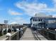 Beautiful marina with boardwalk, boats, restaurant and waterfront views under a blue sky at 60 Rice Ln, Edisto Beach, SC 29438