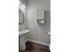 This bathroom showcases a pedestal sink, wood-look floors, and gray walls at 619 Hilchot Dr, Summerville, SC 29486