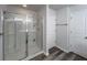 Modern bathroom featuring a glass-enclosed shower, wood-look flooring, and a linen closet for storage at 619 Hilchot Dr, Summerville, SC 29486