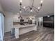 Open kitchen featuring a large island, modern appliances, and decorative lighting at 619 Hilchot Dr, Summerville, SC 29486