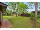 Spacious backyard featuring a storage shed, mature trees, and ample green space for outdoor activities and relaxation at 6305 Brandt St, North Charleston, SC 29406