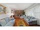 Spacious living room with hardwood floors, a brick fireplace, and comfortable blue sofas at 6305 Brandt St, North Charleston, SC 29406