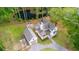 Attractive aerial view of the white home, detached garage, charming fire pit and the calming pond at 6373 Farm House Rd, Ravenel, SC 29470