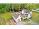 Stunning aerial view of a charming home with a pond, a separate garage, and lush landscaping at 6373 Farm House Rd, Ravenel, SC 29470