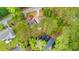 Aerial view of home and garage, pond, and fire pit surrounded by beautiful trees at 6373 Farm House Rd, Ravenel, SC 29470