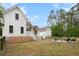 Rear exterior of home, showing a patio, fire pit, and lush landscaping, perfect for outdoor enjoyment at 6373 Farm House Rd, Ravenel, SC 29470