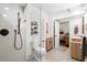 Bright bathroom featuring a modern vanity and spacious walk-in shower with matte-black fixtures at 6373 Farm House Rd, Ravenel, SC 29470