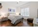 Bright bedroom featuring a bed with patterned bedding, side table, and a window with natural light at 6373 Farm House Rd, Ravenel, SC 29470