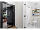 View of hallway featuring a secure vault door and a half bathroom with white hexagon floor tile at 6373 Farm House Rd, Ravenel, SC 29470
