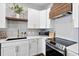 Charming kitchen with white cabinets, stainless steel appliances, and stylish butcher block range hood at 6373 Farm House Rd, Ravenel, SC 29470