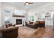 Open-concept living space featuring a fireplace, hardwood floors, and a view of the kitchen at 6373 Farm House Rd, Ravenel, SC 29470