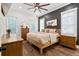Comfortable main bedroom with rustic wood floors, a ceiling fan, and lots of natural light at 6373 Farm House Rd, Ravenel, SC 29470