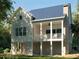 Rear elevation of a light colored home with a breezy, covered porch looking out to the yard at 7033 Sounding Ln, Johns Island, SC 29455