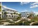 Community landscape with multiple buildings, pools, palm trees and manicured walking trails at 7059 Sounding Ln, Johns Island, SC 29455