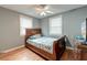 Bedroom with grey walls, hardwood floors, ceiling fan, and two windows at 757 Longfellow Rd, Charleston, SC 29407