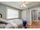 Cozy bedroom featuring hardwood floors, a ceiling fan, and plenty of natural light through a large window at 757 Longfellow Rd, Charleston, SC 29407