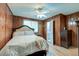 Inviting bedroom with wood paneled walls, hardwood floors, and a ceiling fan at 757 Longfellow Rd, Charleston, SC 29407