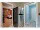 Open view of stainless steel refrigerator with doorways to the bedroom and the exterior at 757 Longfellow Rd, Charleston, SC 29407