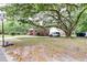 Charming brick home with a large shade tree, driveway and a basketball hoop at 757 Longfellow Rd, Charleston, SC 29407