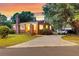 Beautiful brick home with a lovely sunset, a large tree, and spacious driveway at 757 Longfellow Rd, Charleston, SC 29407