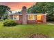 Classic brick home with a chimney, a well-maintained lawn, and a charming front entrance, set against a sunset background at 757 Longfellow Rd, Charleston, SC 29407