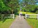 Entrance to West Ashley Greenway with a paved trail surrounded by lush trees and greenery at 757 Longfellow Rd, Charleston, SC 29407