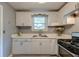 Bright kitchen with white cabinets, quartz countertops, stainless steel sink, and modern appliances at 757 Longfellow Rd, Charleston, SC 29407