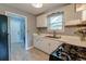 Well-lit kitchen features white cabinets, modern appliances, and a view to other rooms at 757 Longfellow Rd, Charleston, SC 29407