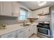 Well-lit kitchen with white cabinets, stainless steel appliances, and modern countertops at 757 Longfellow Rd, Charleston, SC 29407