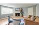 Bright living room with hardwood floors, a fireplace, and stylish blue velvet chairs at 757 Longfellow Rd, Charleston, SC 29407